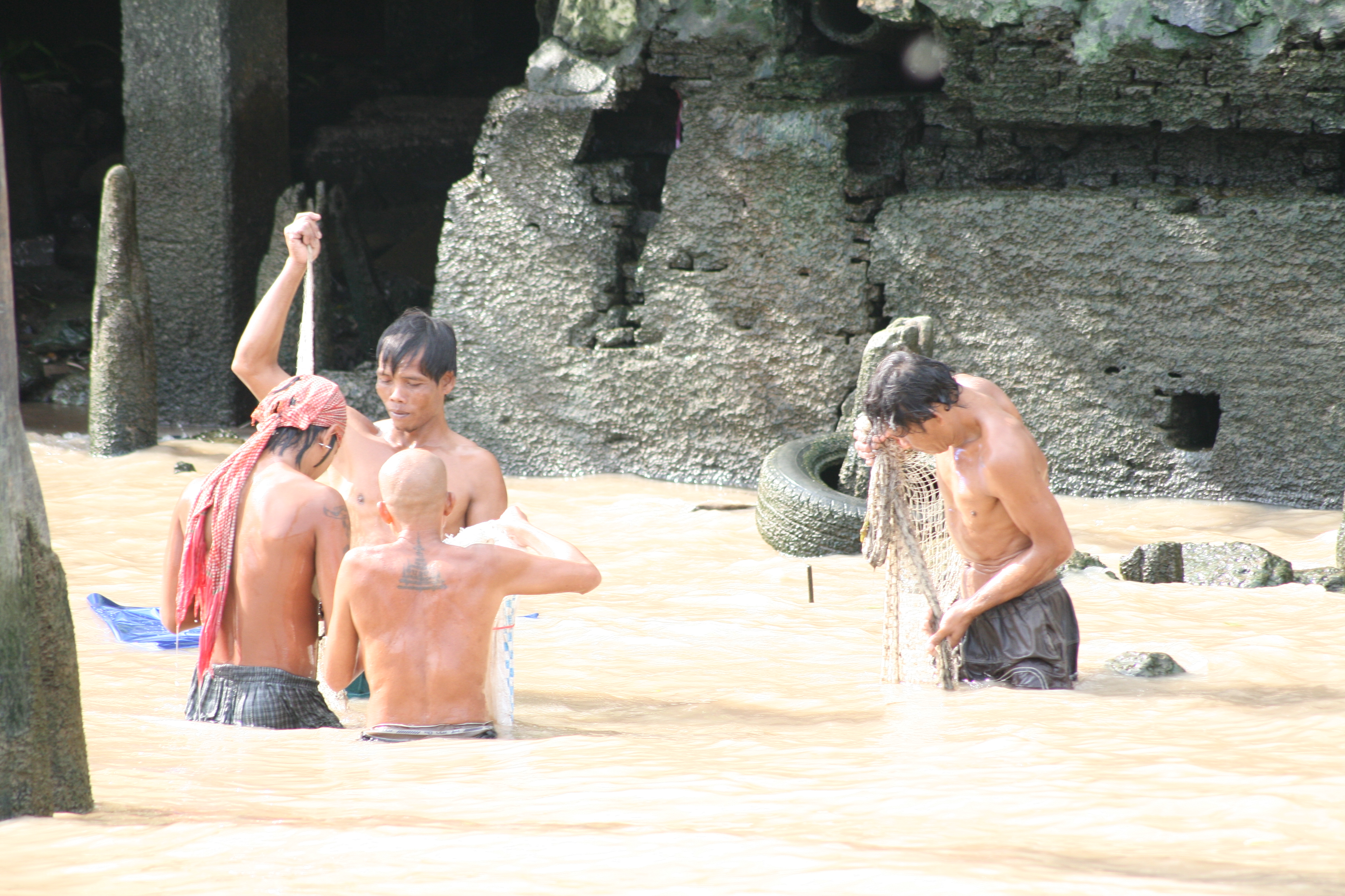 men washing in river, Thailand